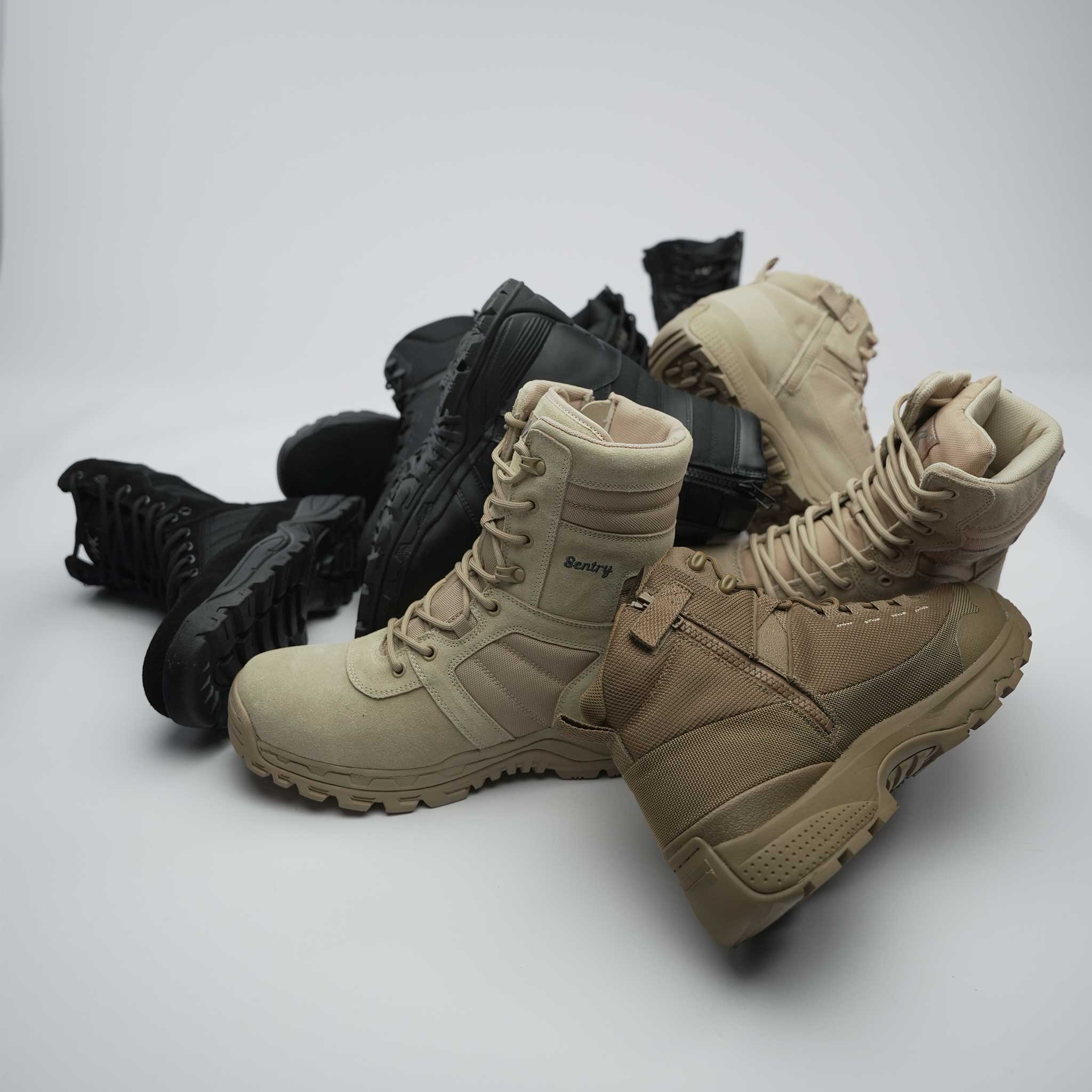 combat and tactical boots in a pile