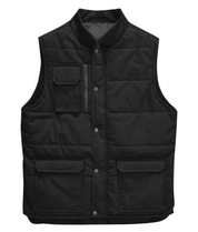 A black utility vest with a high collar, snap-button front closure, and quilted stitching. The vest features a zippered chest pocket with a flap, along with two large front flap pockets near the hem. Designed for durability and functionality, ideal for workwear or outdoor use. by MAK Boots & Garments