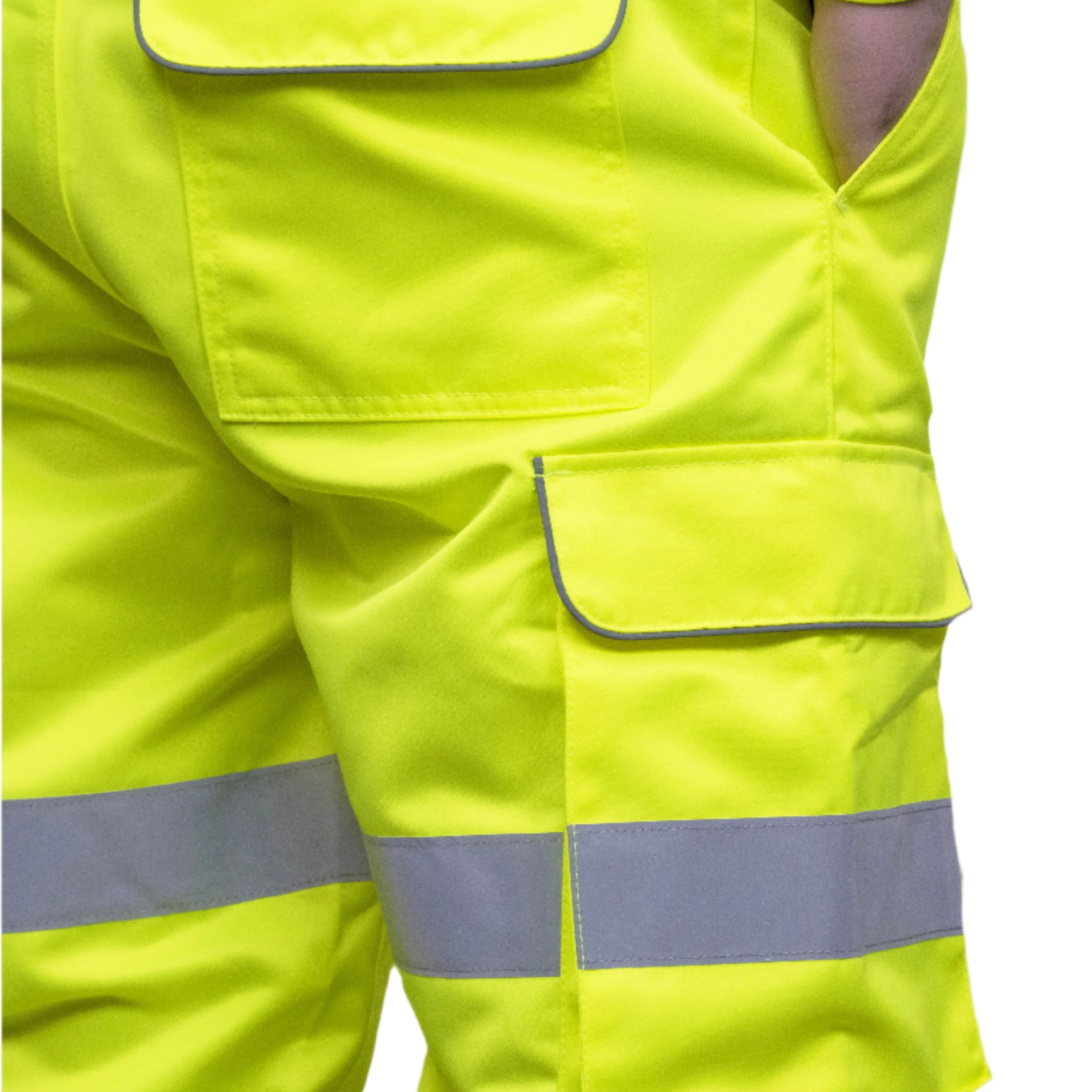 A person wearing high-visibility yellow work trousers with reflective grey stripes around the knees, shins, and thighs. The pants have a cargo pocket on the side and are paired with black safety boots. Only the lower half of the person is visible. The trousers appear to be part of a workwear or safety uniform. by MAK Boots & Garments