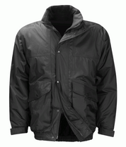 Black insulated jacket with a water-resistant outer shell, zip and snap-button closure, storm flap, fleece-lined collar, and dual front flap pockets for utility and warmth  by MAK Boots & Garments.