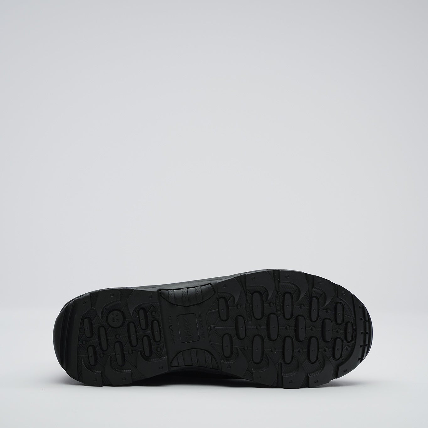 Black shoe sole on a light gray background