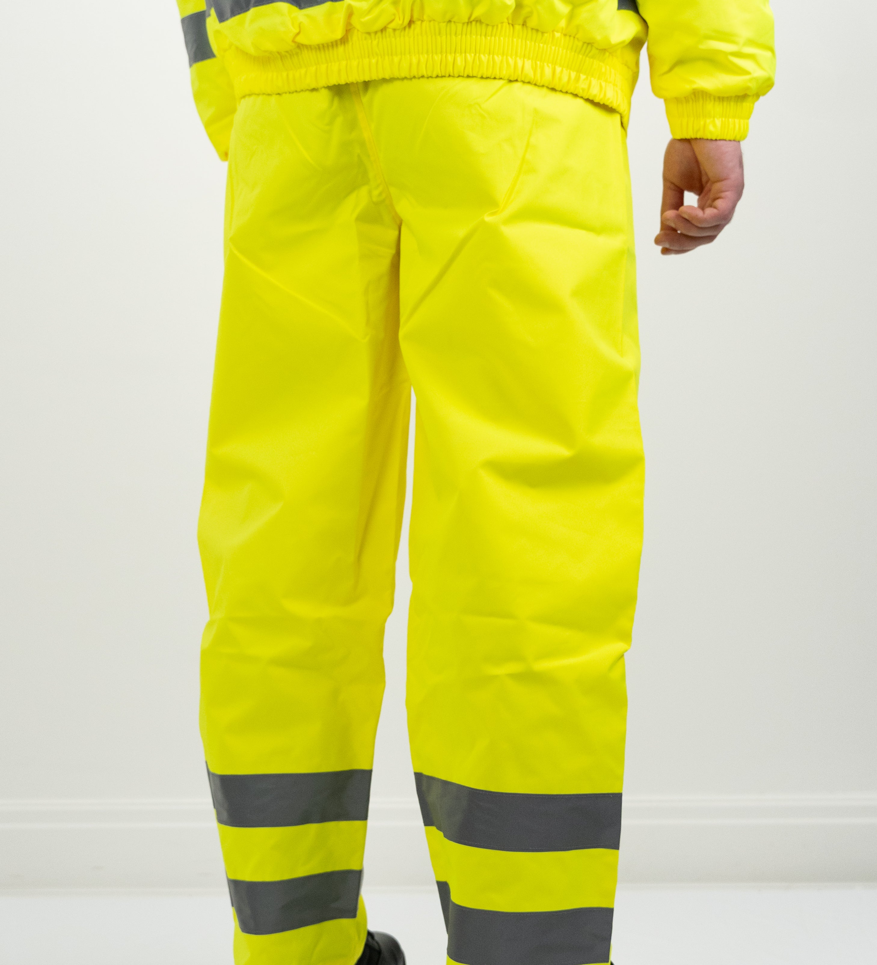 hi-vis yellow over trousers rear view with silver reflective strip on ankle