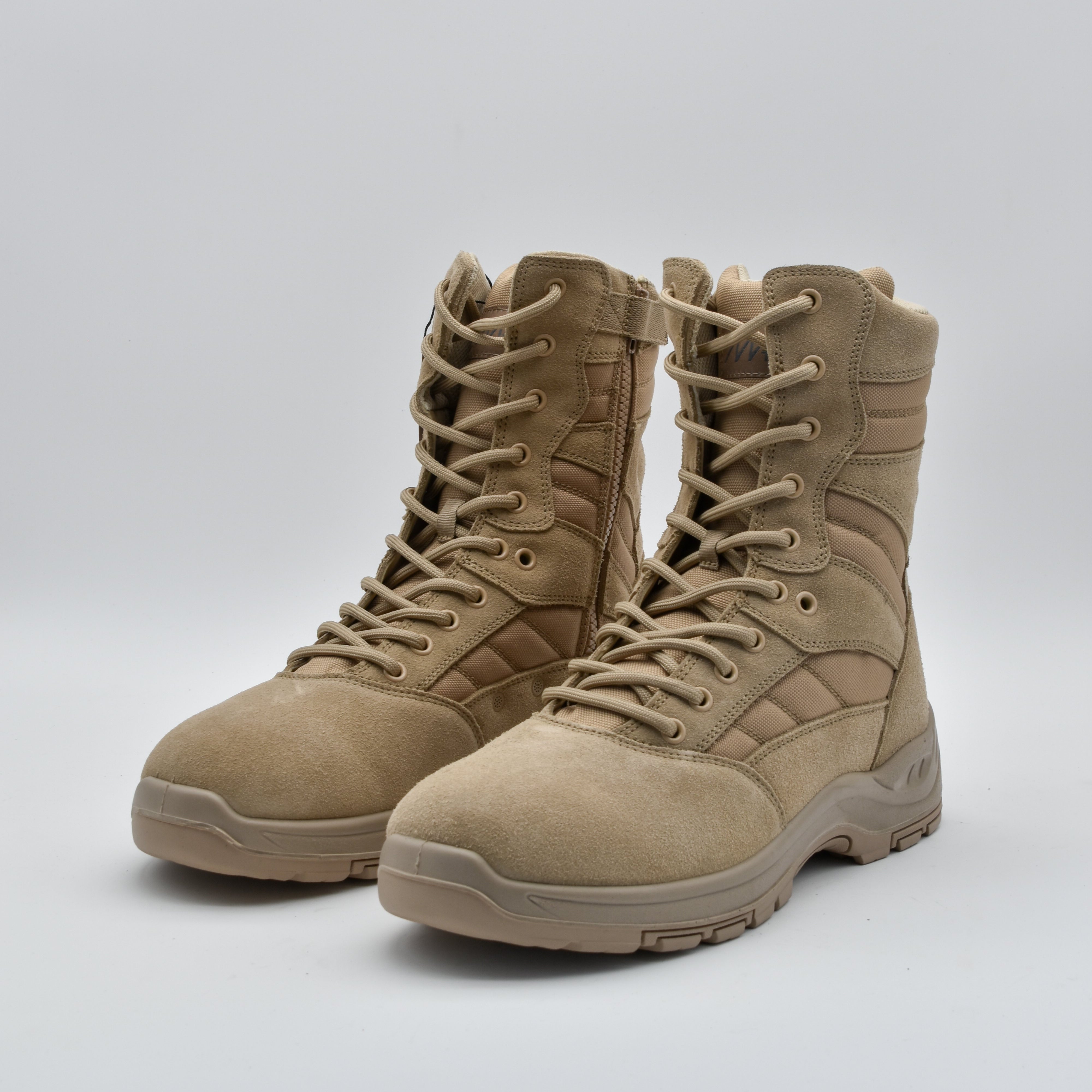 A pair of tan tactical combat boots with laces, shown on a light gray studio background.
