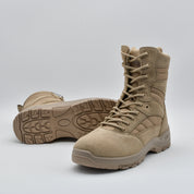 A pair of tan tactical combat boots with laces, shown on a light gray studio background. One boot is positioned upright to show the side profile, while the other lies on its side to display the outsole tread.
