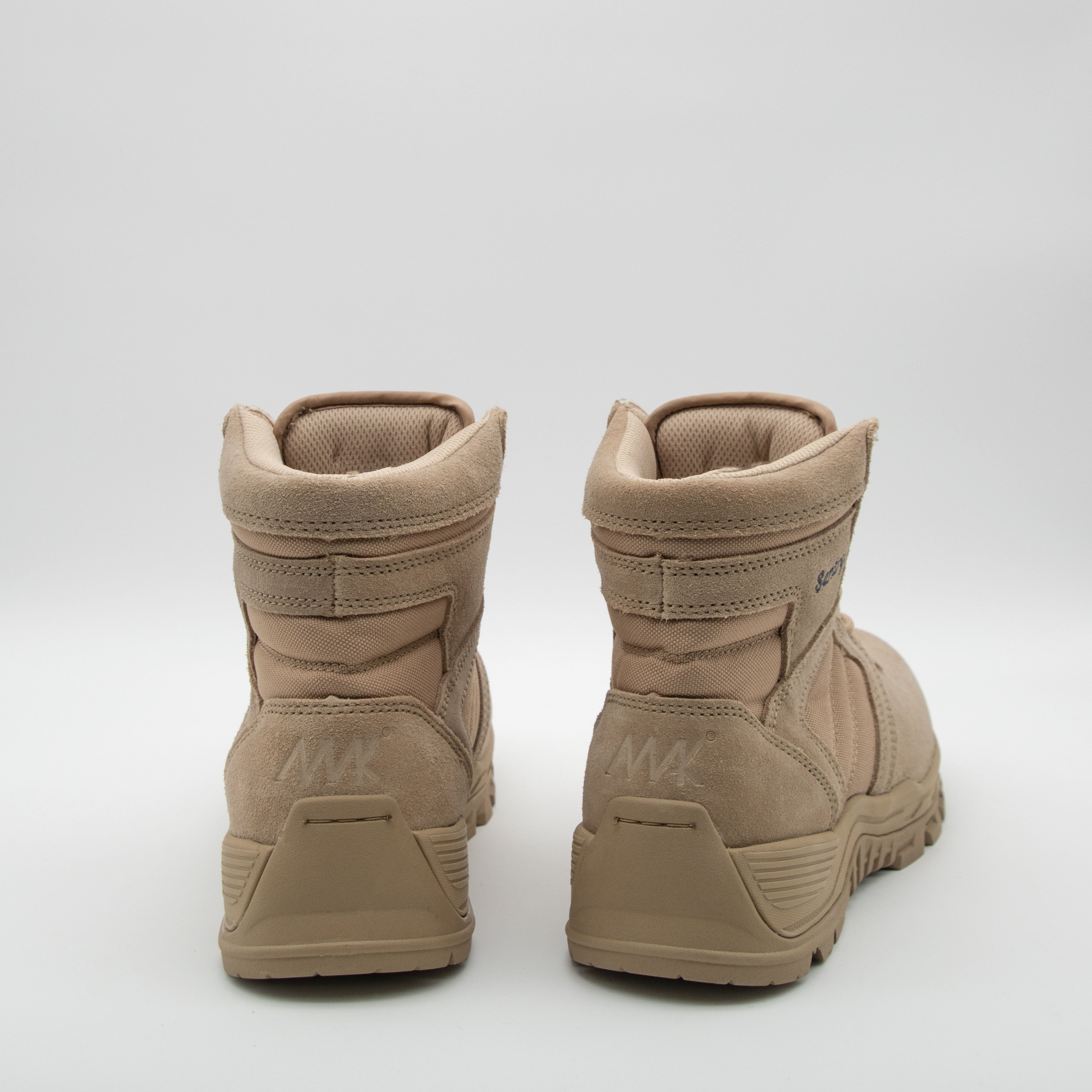 Pair of tan boots on a white background