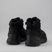 Pair of black high-top boots on a light grey background