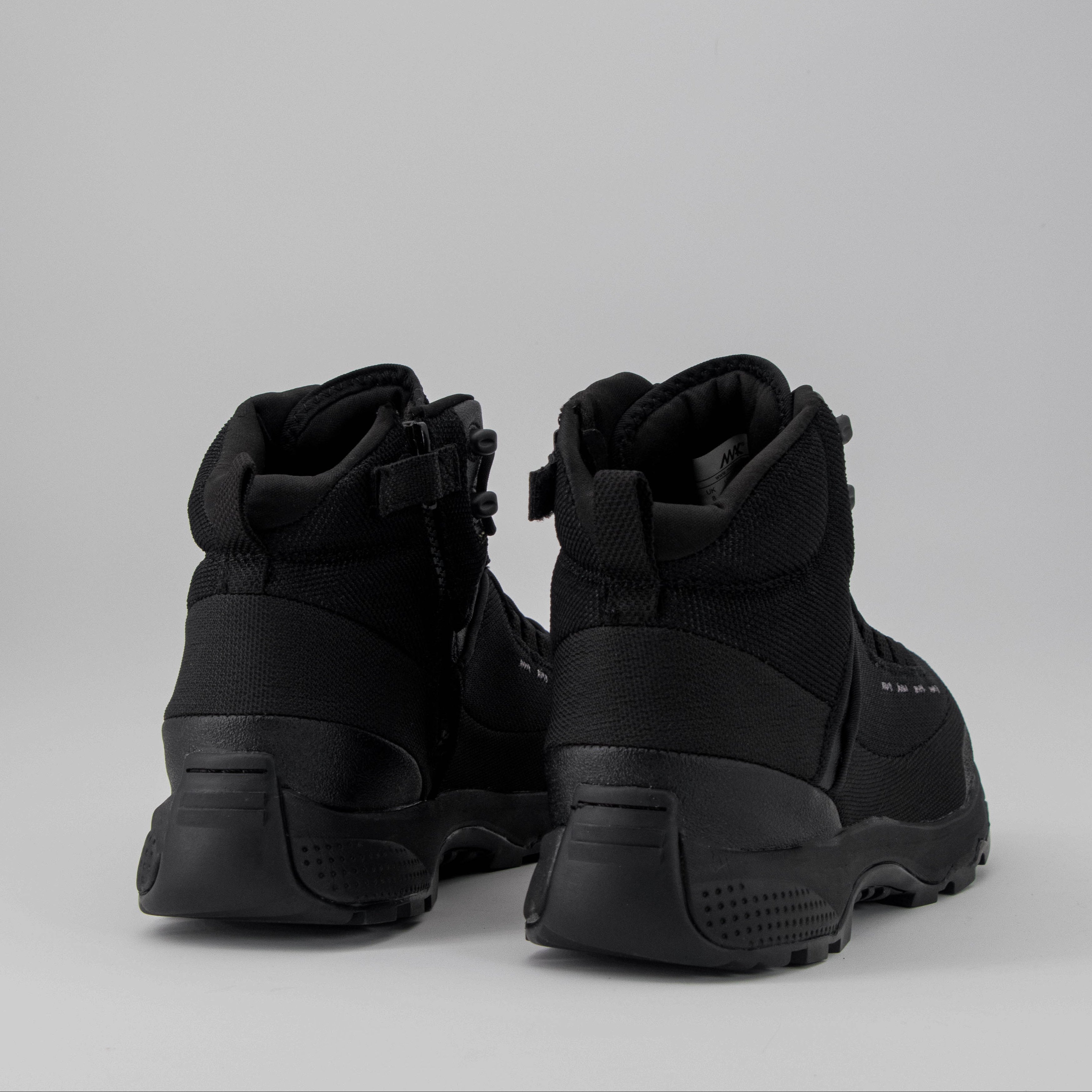 Pair of black high-top boots on a light grey background