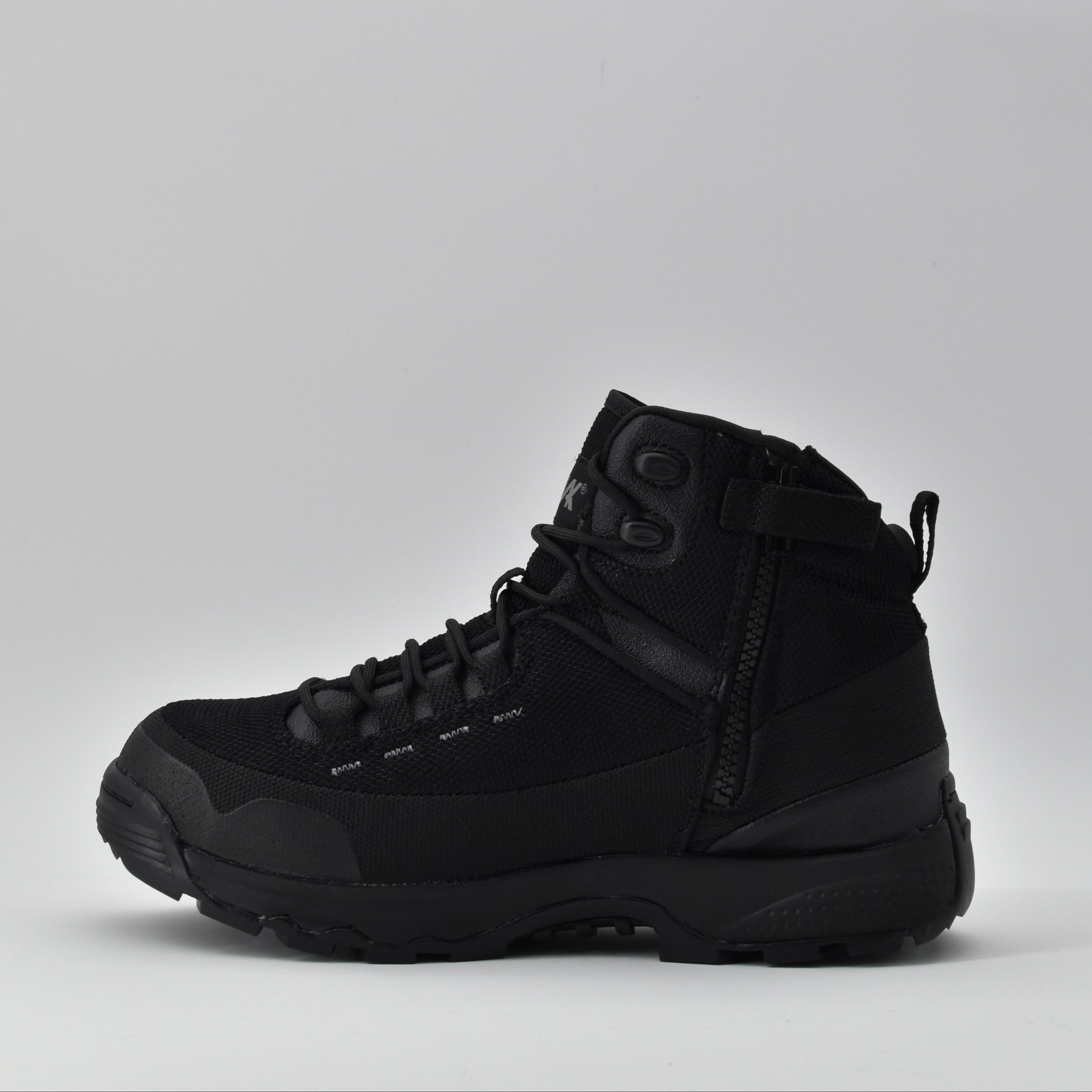 Black combat boots on a light grey background side view