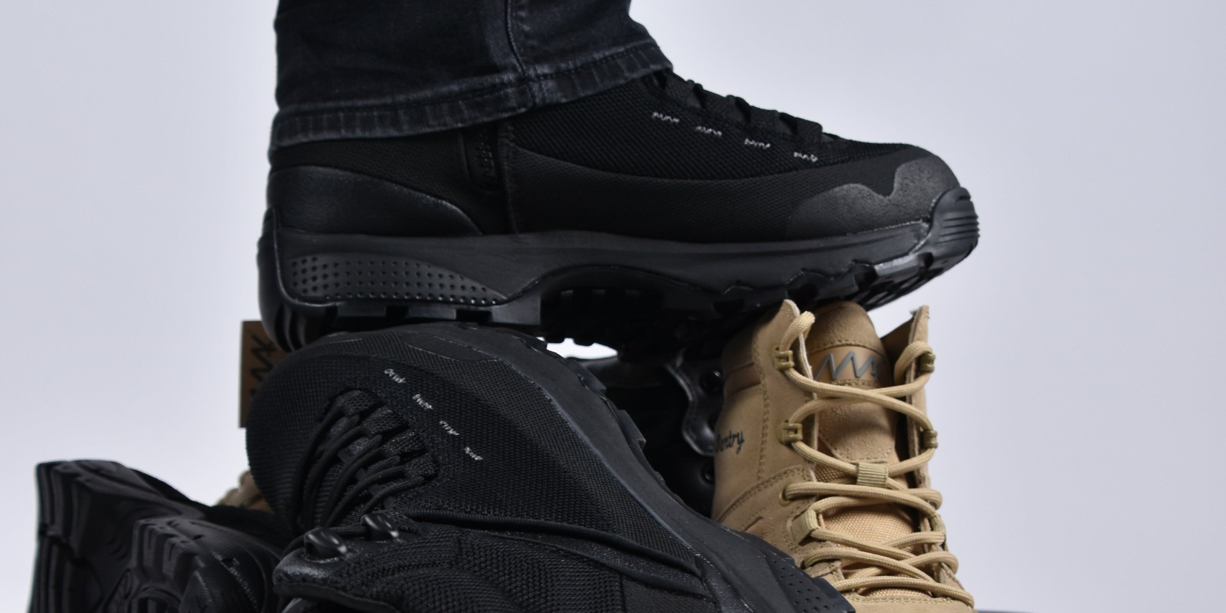 Black and tan boots on a white background