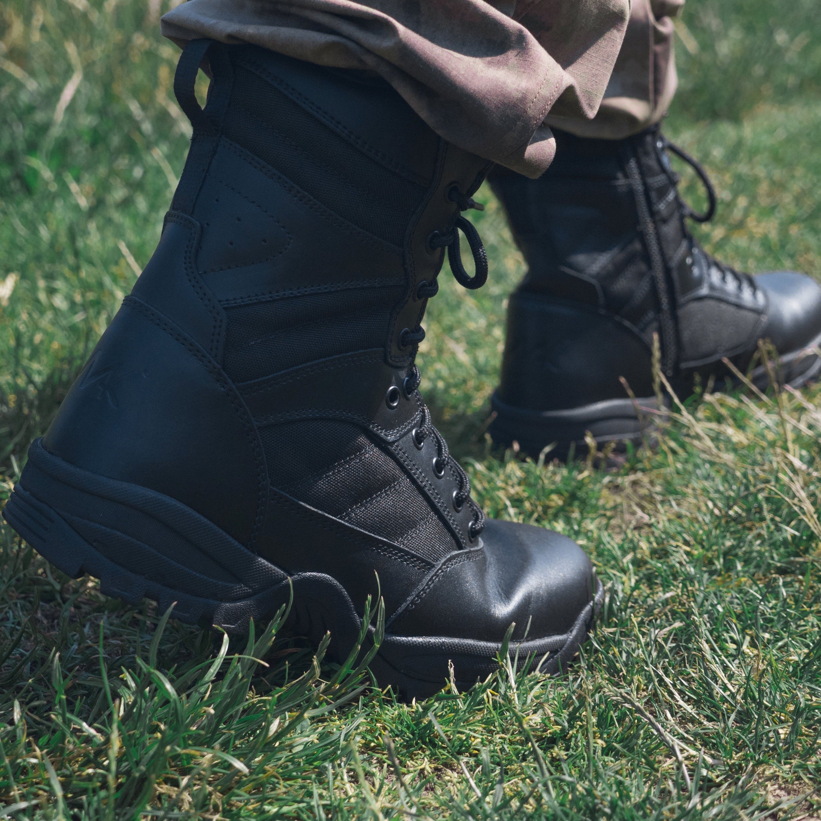 protector 9" combat boot walking in grass