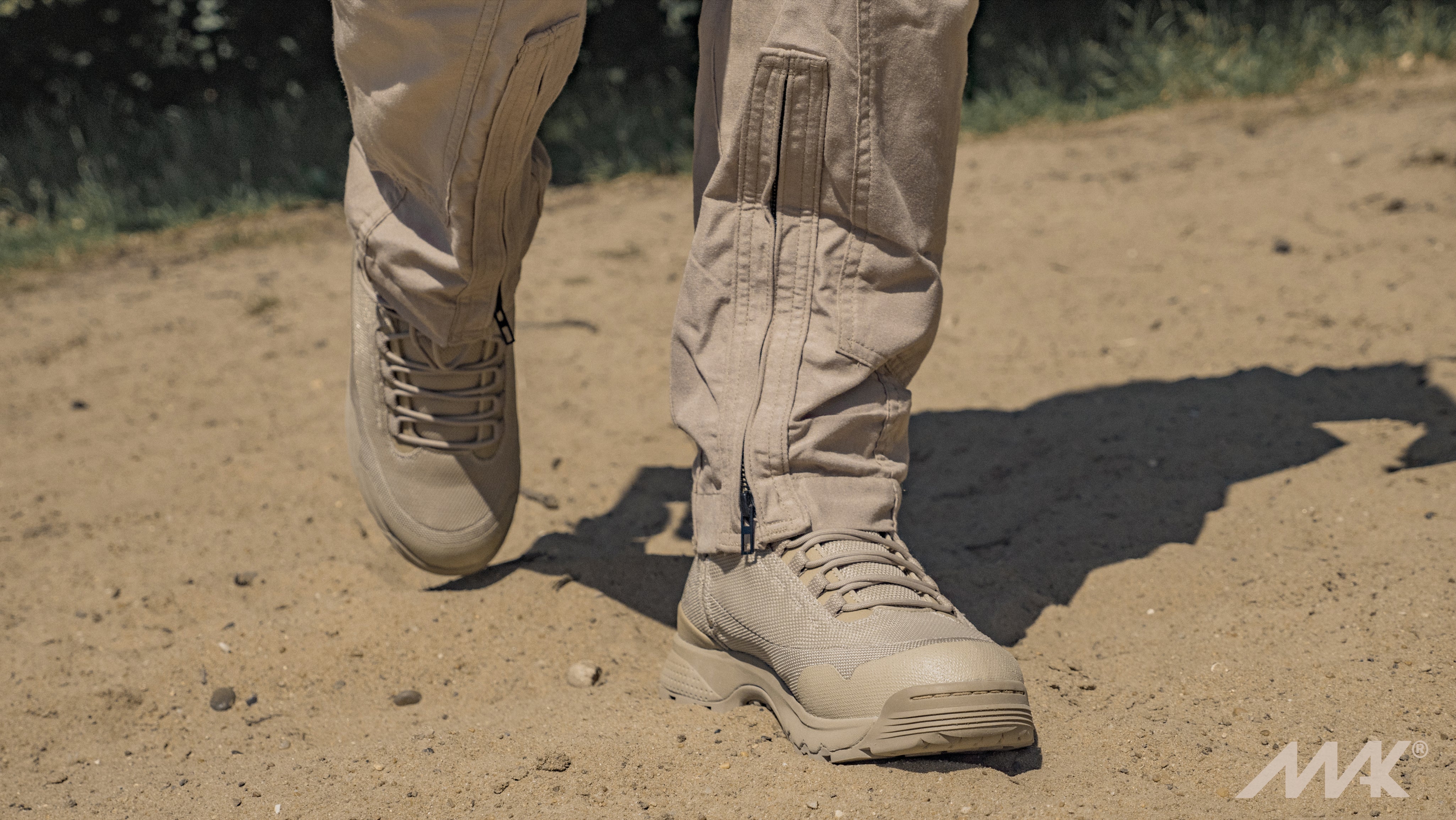 delta x desert tan military boot walking through the sand