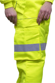 A person wearing high-visibility yellow work trousers with reflective grey stripes around the knees, shins, and thighs. The pants have a cargo pocket on the side and are paired with black safety boots. Only the lower half of the person is visible. The trousers appear to be part of a workwear or safety uniform. by MAK Boots & Garments