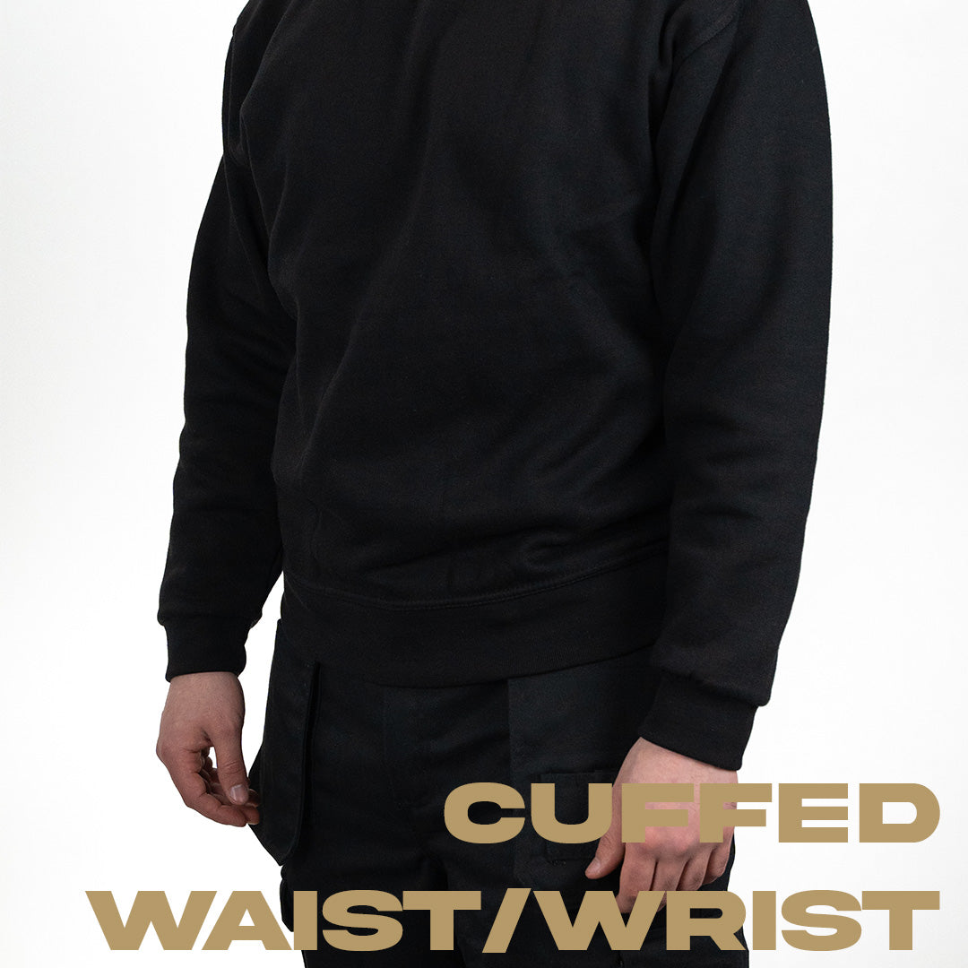 person wearing black work jumper with cuffed wrists and waist