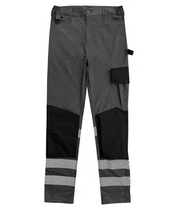 Dark grey and black work trousers featuring reflective chevron stripes at the ankles, cargo pocket, tool loops, reinforced knee patches, and elastic waistband for comfort. Designed for durability and high visibility in working environments. By MAK Boots & Garments.
