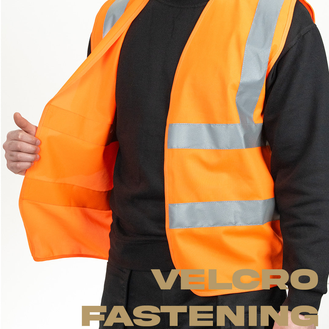 model holding orange hi vis vest on one side to show the opening